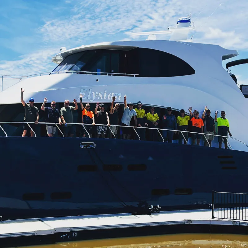 The Mason Marine Industries team of boat builders lined up on the deck of the Elysian catamaran